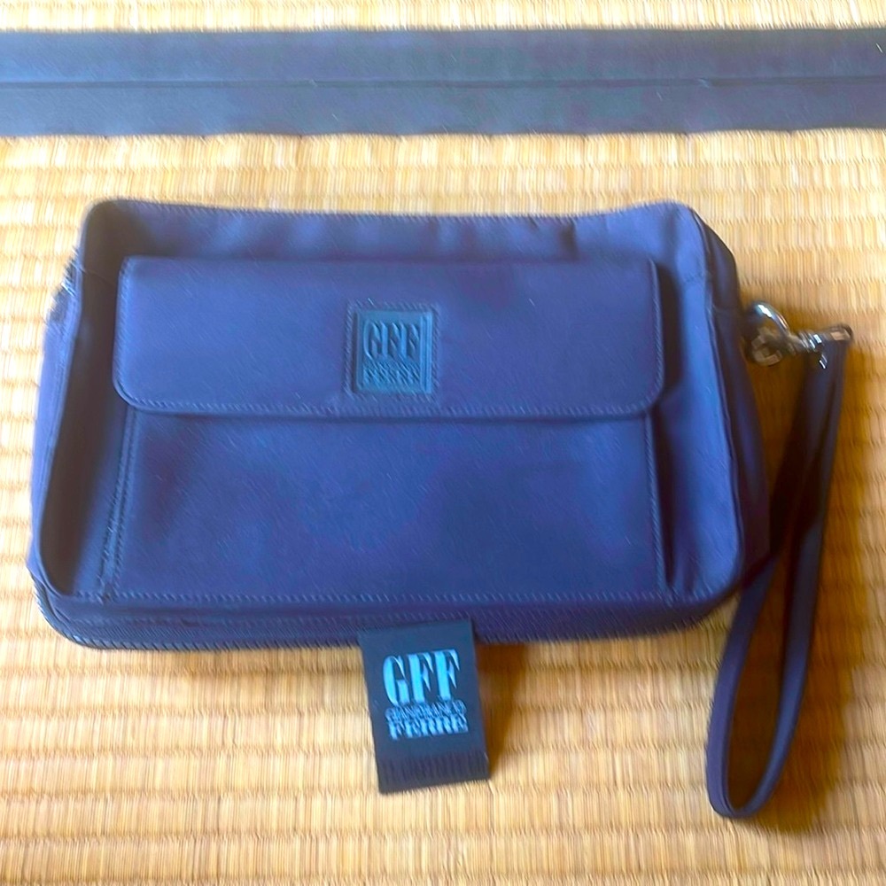 Gianfranco Ferre nylon carry all zip around clutch.